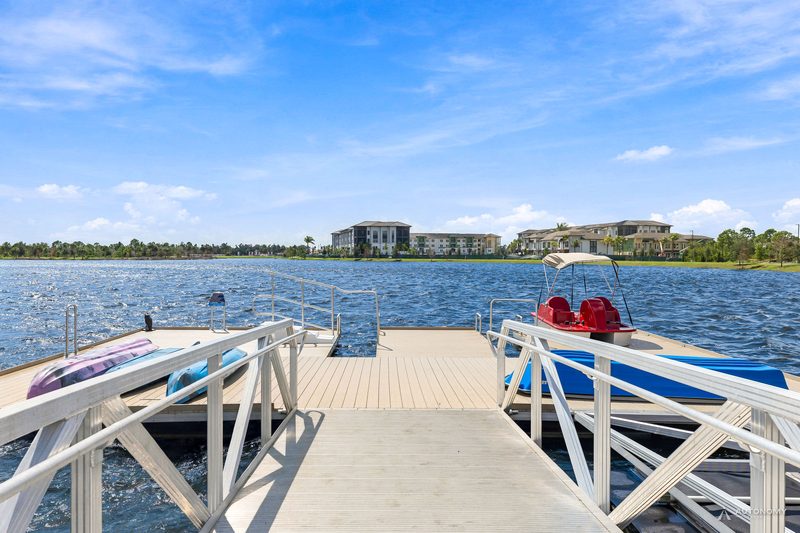Floating dock with a red-seat pedal boat on the Grand Lake in Wellen Park